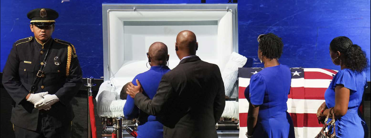 Mourners file past the casket of Dallas police officer Darron Burks.